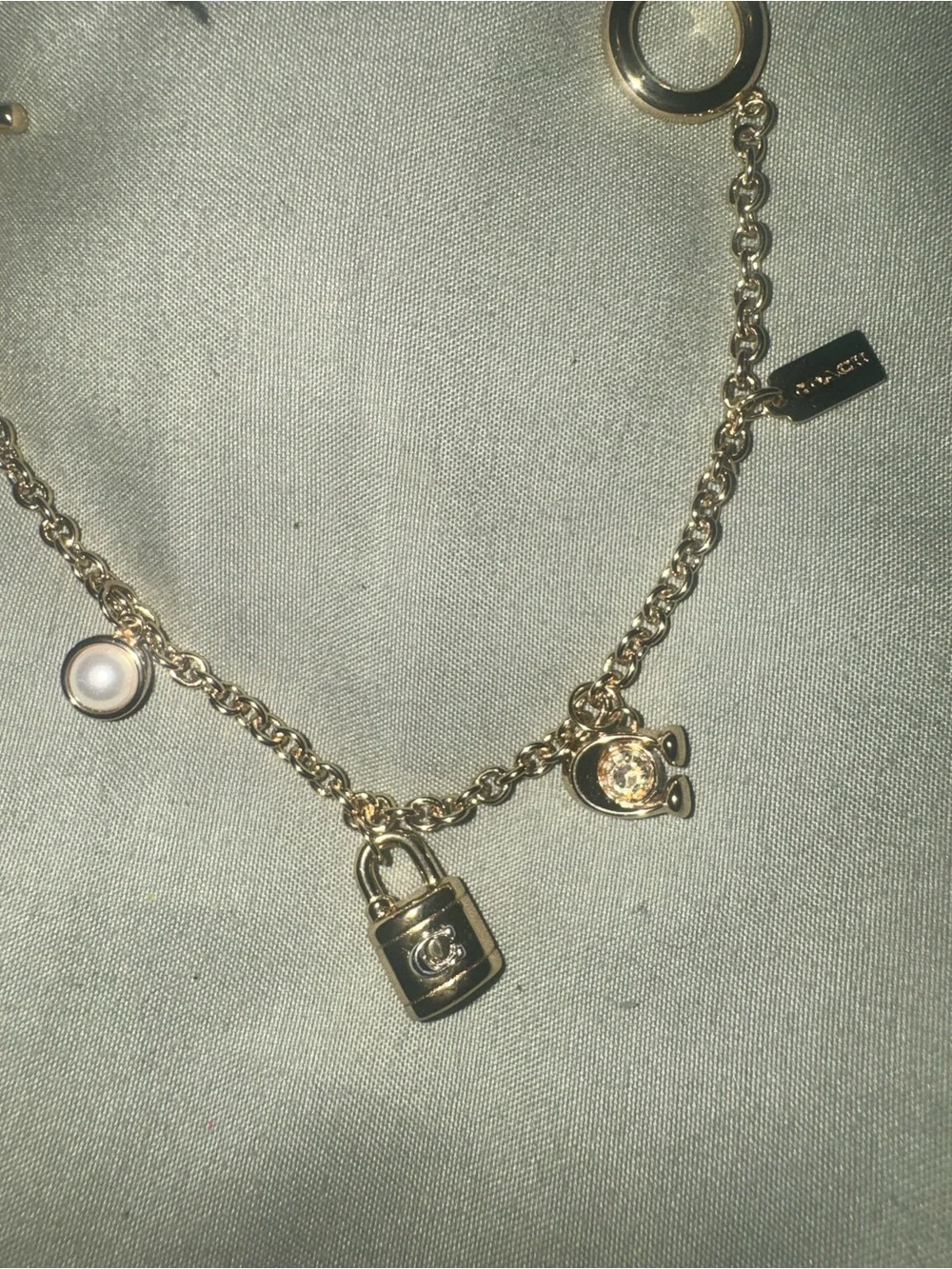 Coach Gold tone Charm Bracelet with Padlock, Key and Pearl Accents CD855 A31